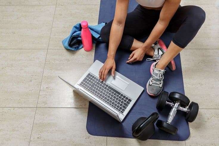 Person choosing a workout program on a laptop